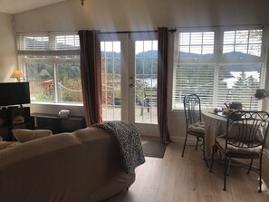Deluxe Studio Suite, 1 King Bed, Kitchenette (Hummingbird Suite) | Living area | LED TV, streaming services - Moonlit Cove B&B (Sooke)