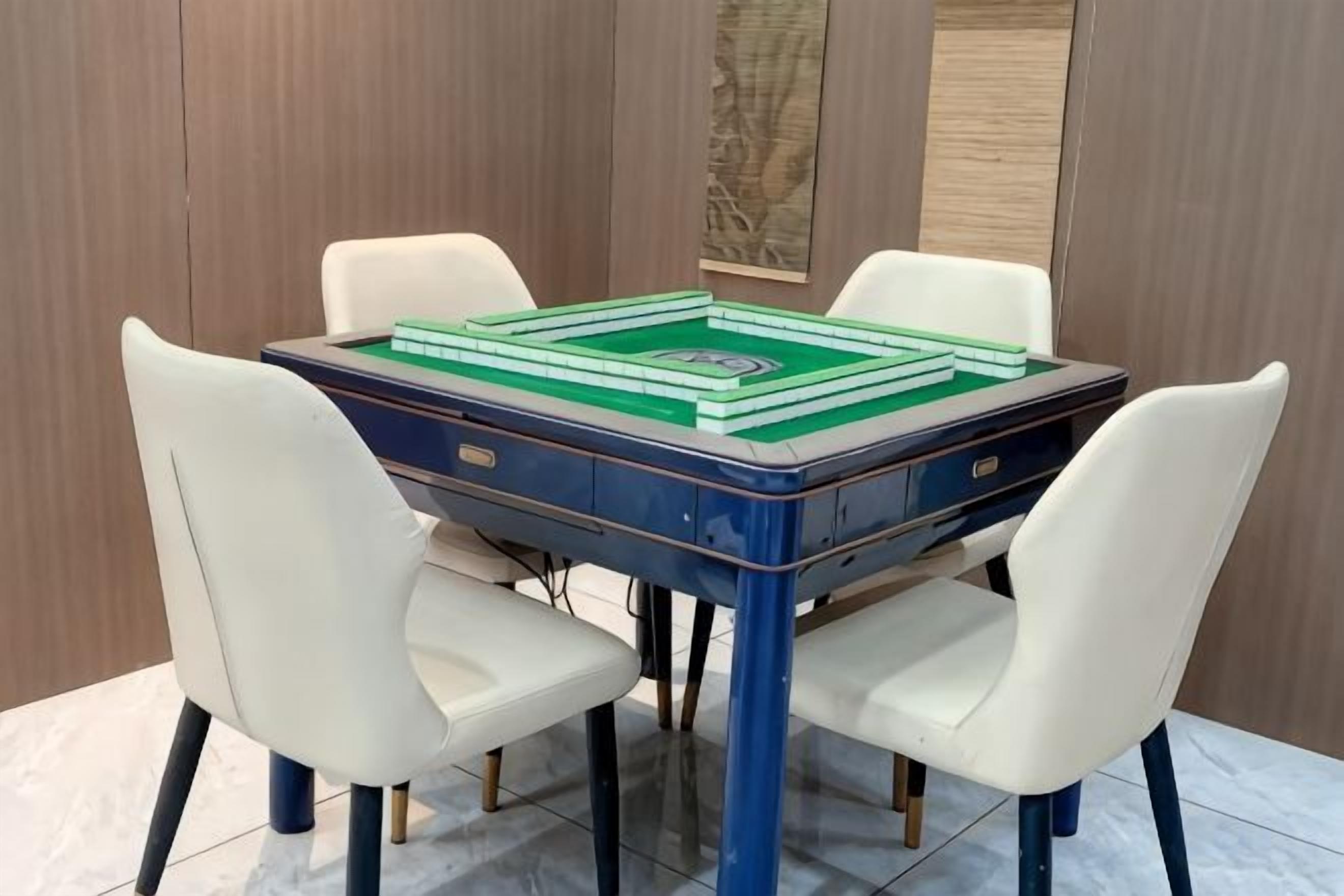 A table with a board game, four chairs, and a wooden wall.