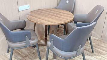 A round table with four grey chairs around it.
