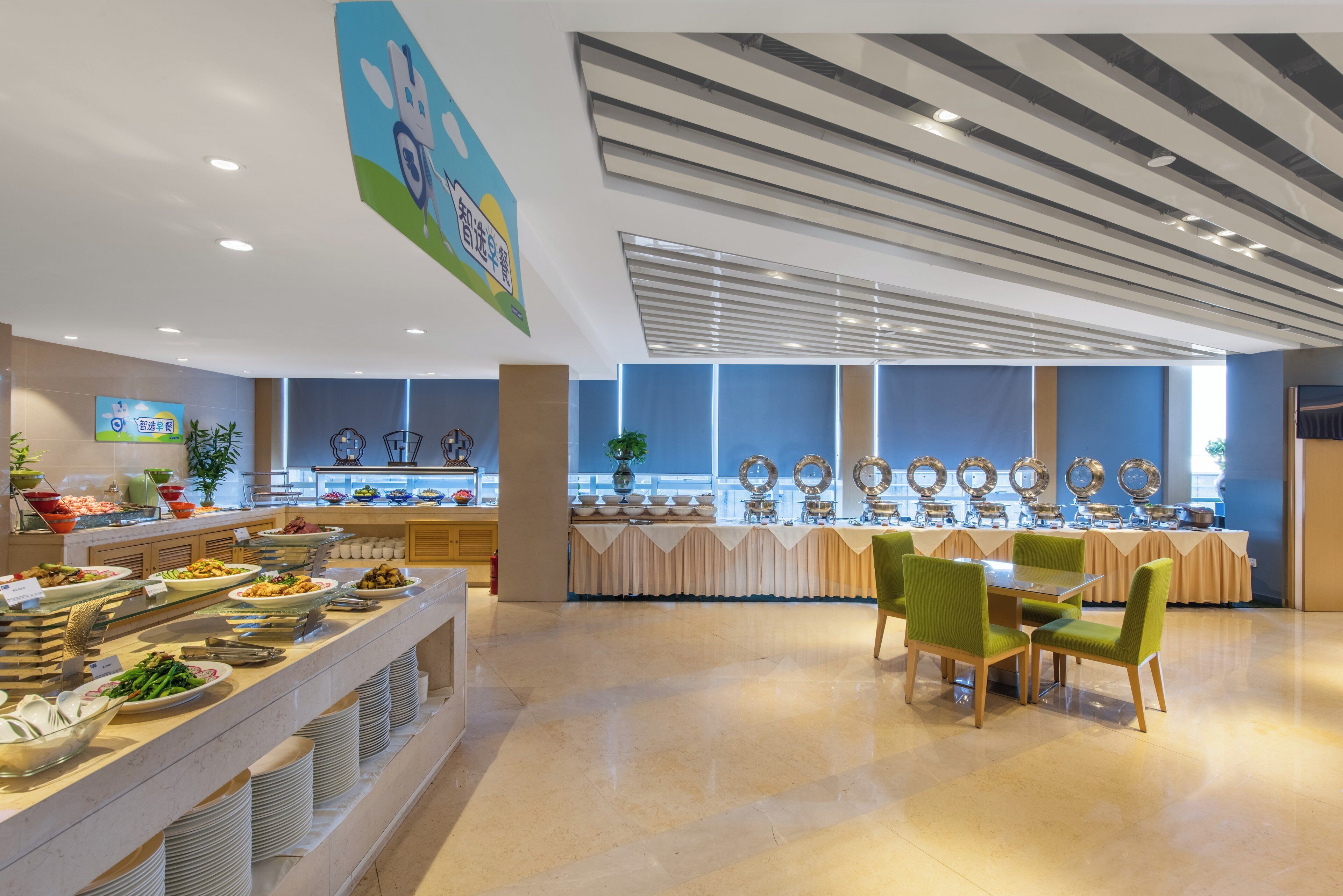 A buffet area with multiple food stations, a seating area with chairs, and a ceiling with a unique design.