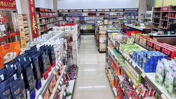 A supermarket aisle with various packaged goods and household items.