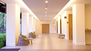 A modern hotel lobby with a long corridor, seating area, and a reception desk. - ibis Styles Krabi Ao Nang (Krabi)