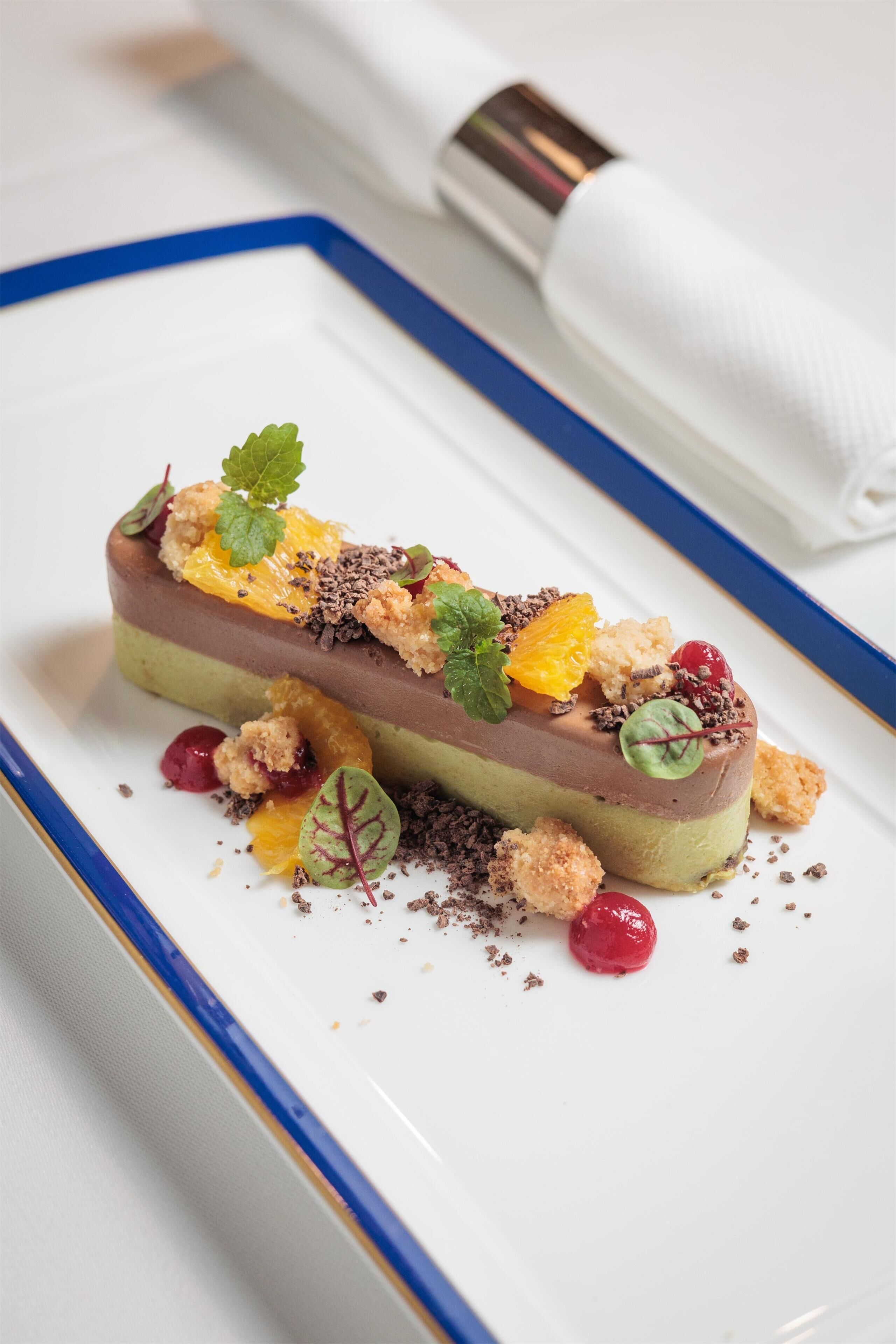 A dessert on a white plate with a blue rim.