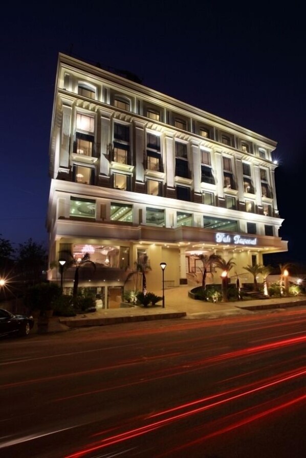 A multi-story hotel with a prominent sign reading "The Peninsula." - Tuli Imperial (Nagpur)