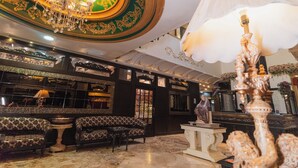A luxurious lobby with ornate chandeliers, plush seating, and a grand staircase. - The Nagpur Ashok (Nagpur)