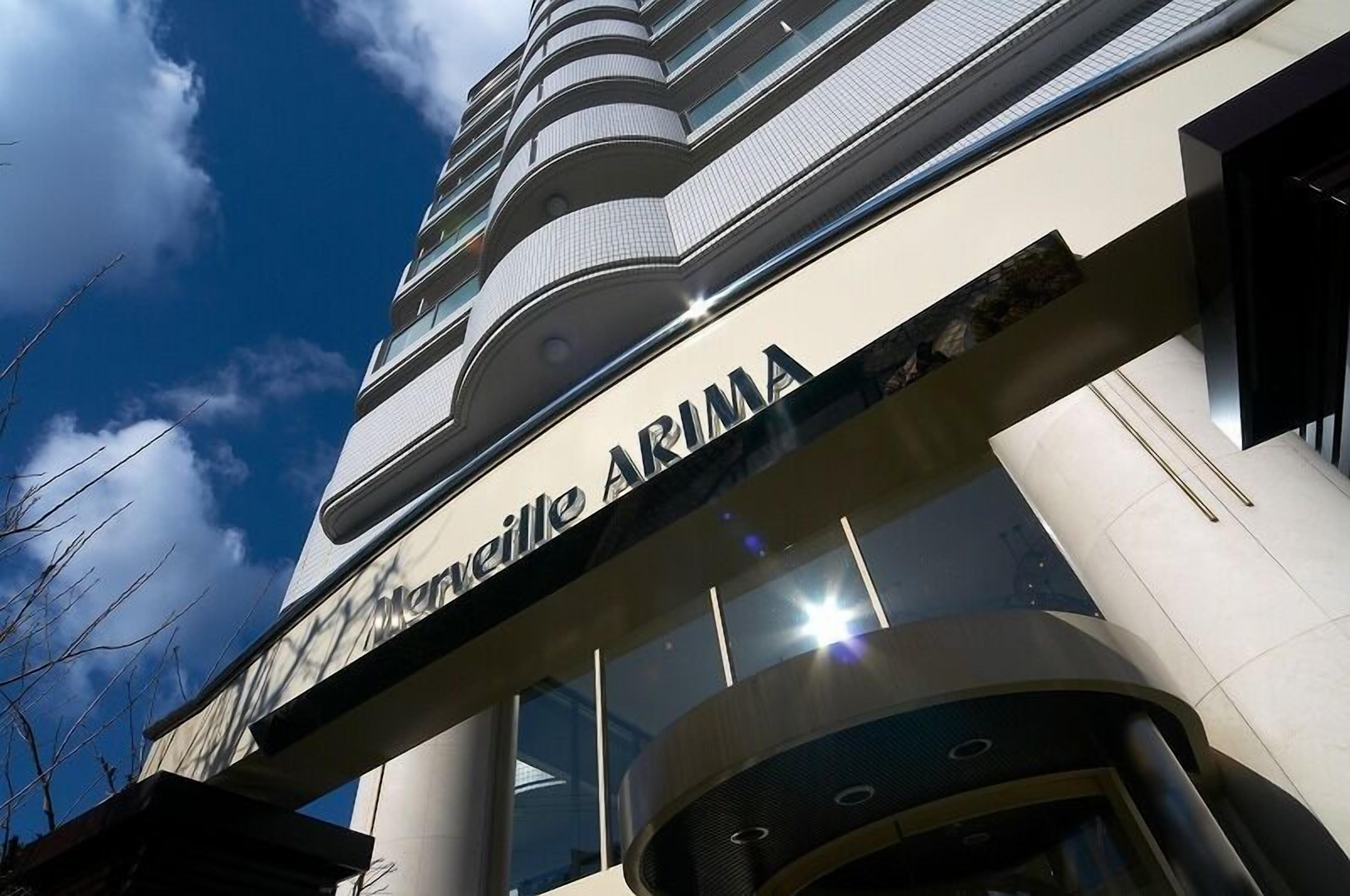 The exterior of the Marville ARIMA building with a clear sky and a modern architectural design.