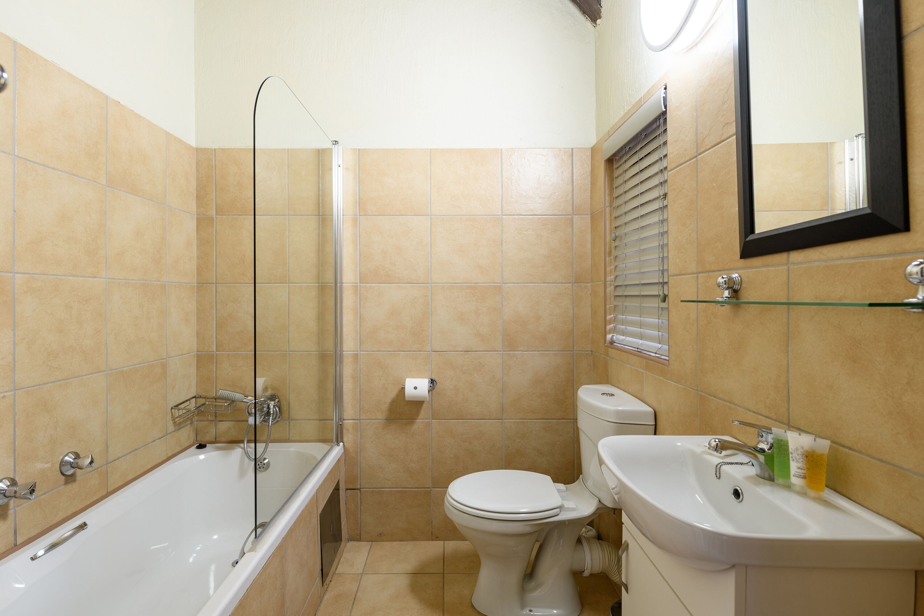 A bathroom with a bathtub, toilet, and sink.