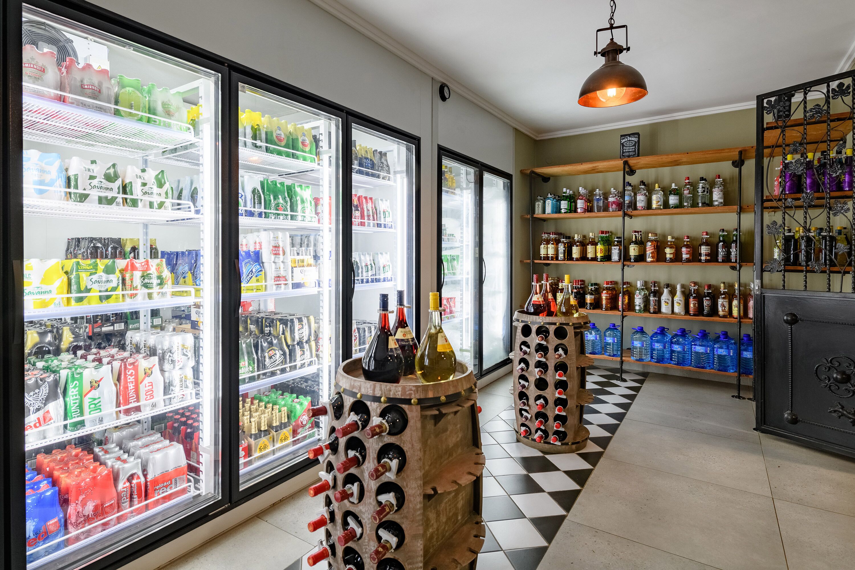 A store with refrigerated beverage cases and shelves stocked with various drinks.