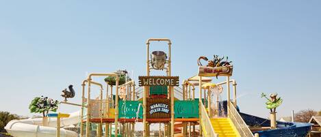 A water park with a 'Welcome' sign, a slide, and a splash zone.