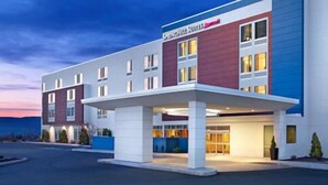 A modern hotel with a covered entrance, multiple floors, and a prominent signage. - SpringHill Suites Sumter (Sumter)