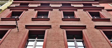 A building facade with multiple rectangular windows and a consistent architectural style.