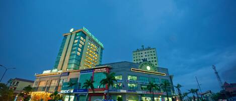 A multi-story hotel with a prominent sign, large windows, and a modern facade.