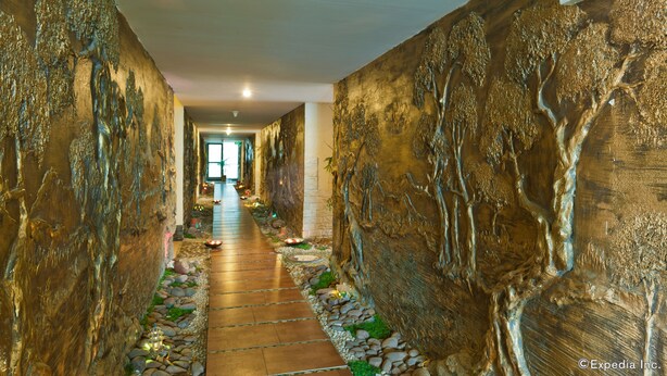A hallway with a stone pathway and decorative wall art. - Muong Thanh Dien Chau Hotel (Dien Chau)