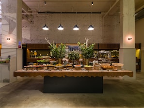 A buffet setup with various food items and decorative plants. - Tune Hotel KLIA - KLIA2 (Sepang)