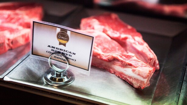 A sign indicating American Prime Rib Eye (500g) on a display with raw meat. - Nightcap at Balaclava Hotel (Earlville)