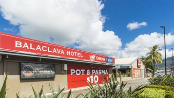 Balaclava Hotel with a sign for Pot & Pasta at $10, a steakhouse, and a Carlton Mid sign.