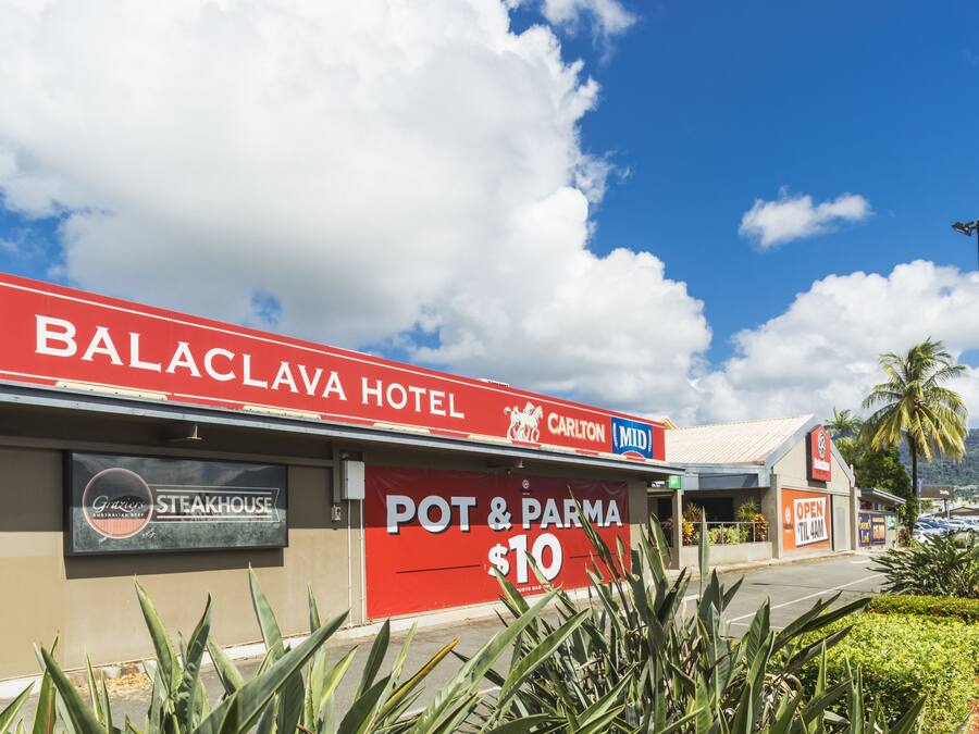 Balaclava Hotel with a sign for Pot & Pasta at $10, a steakhouse, and a Carlton Mid sign.