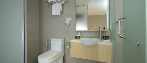 A modern bathroom with a toilet, sink, and shower.