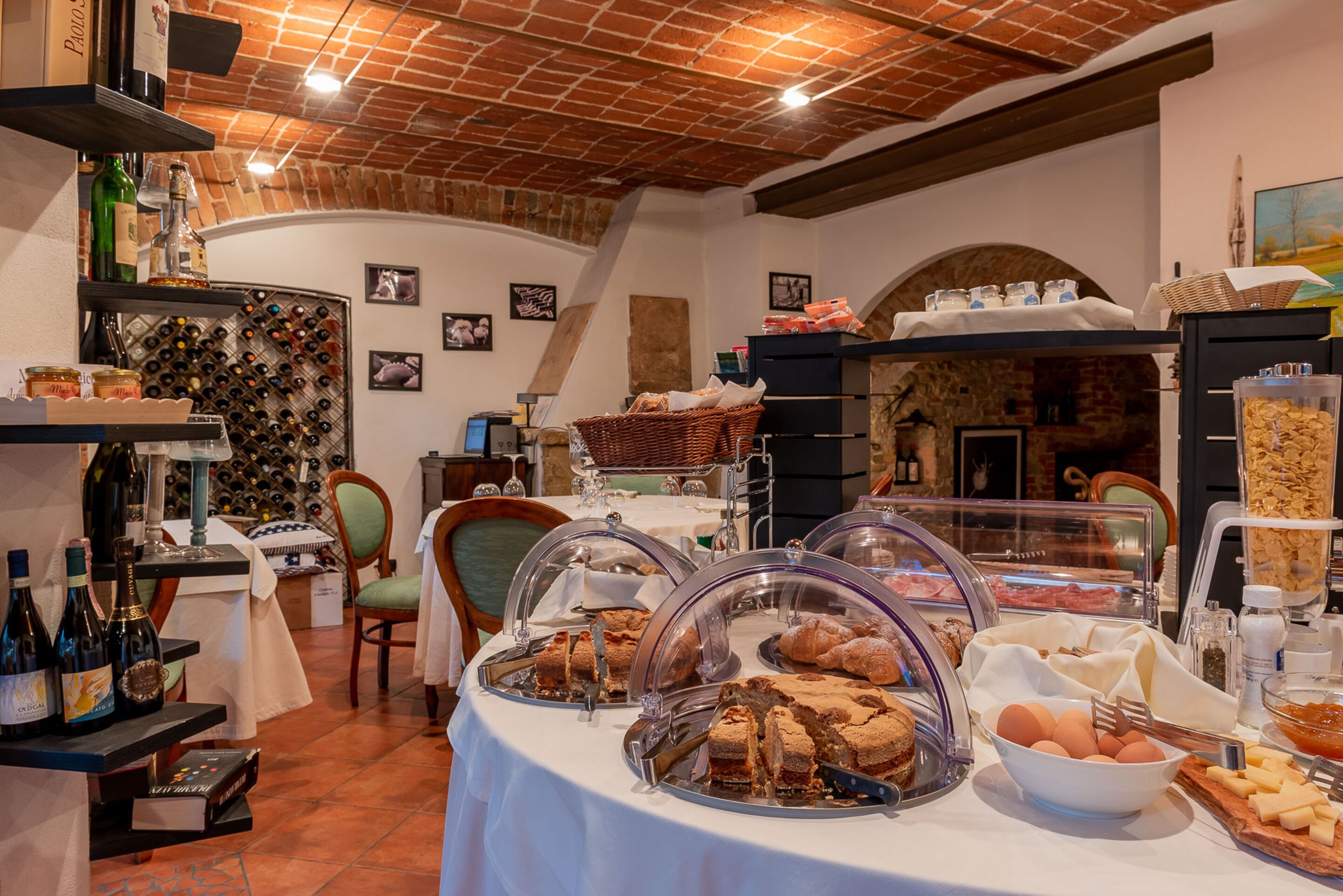 A breakfast buffet with various food items and a wine selection.