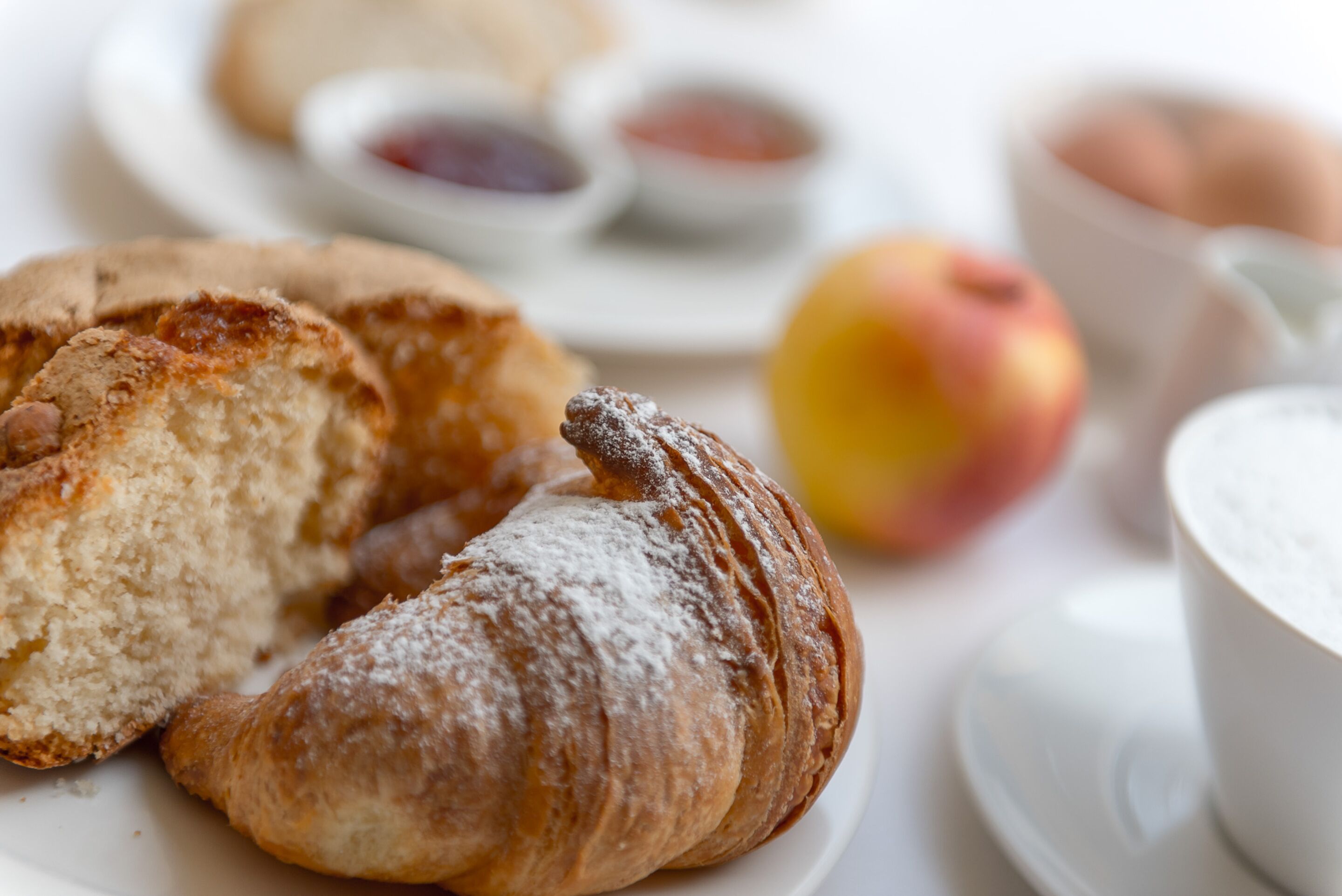 A plate with pastries and a cup of coffee.