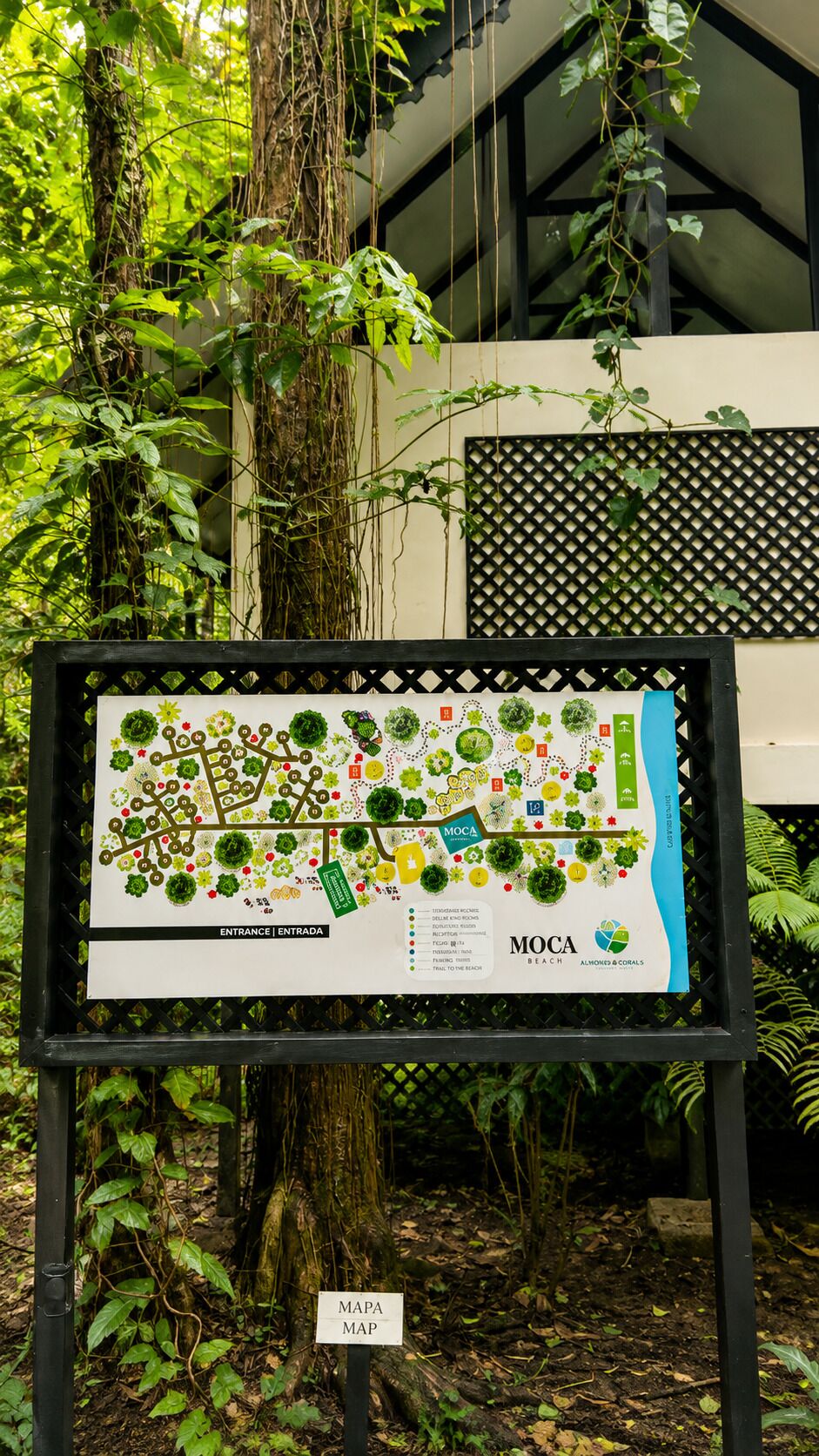 A map of a botanical garden with labeled sections and a sign indicating the entrance.