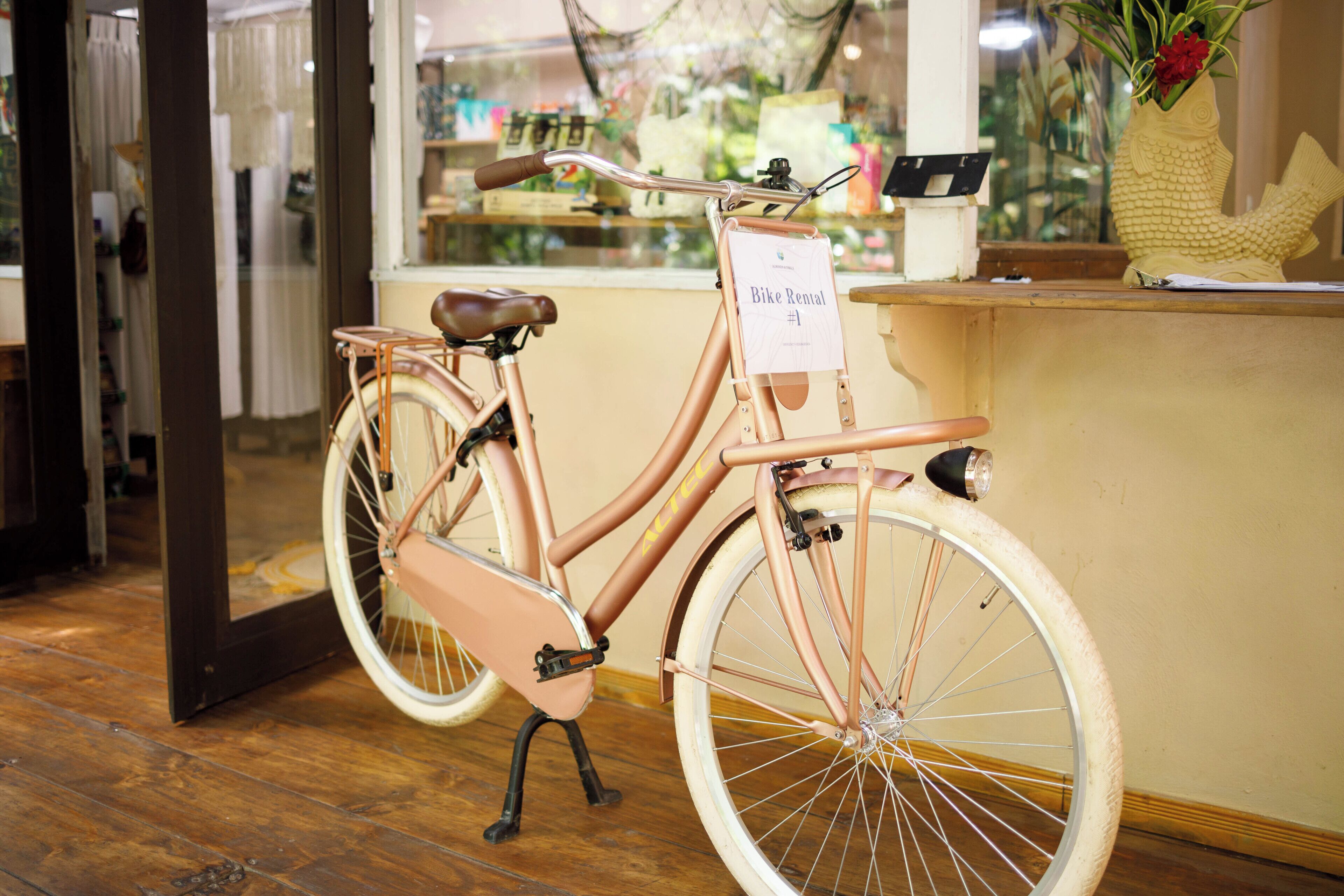 Una bicicleta estática con un letrero que indica que es para alquiler de bicicletas.