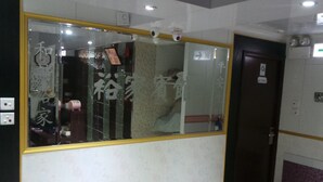 A room with a large mirror, a wardrobe, and a door marked with the number 6101. - Yue Ka Hotel (Kowloon)