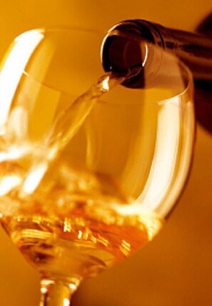 A clear glass of wine being poured. - Tarawade Clarks Inn (Pune)