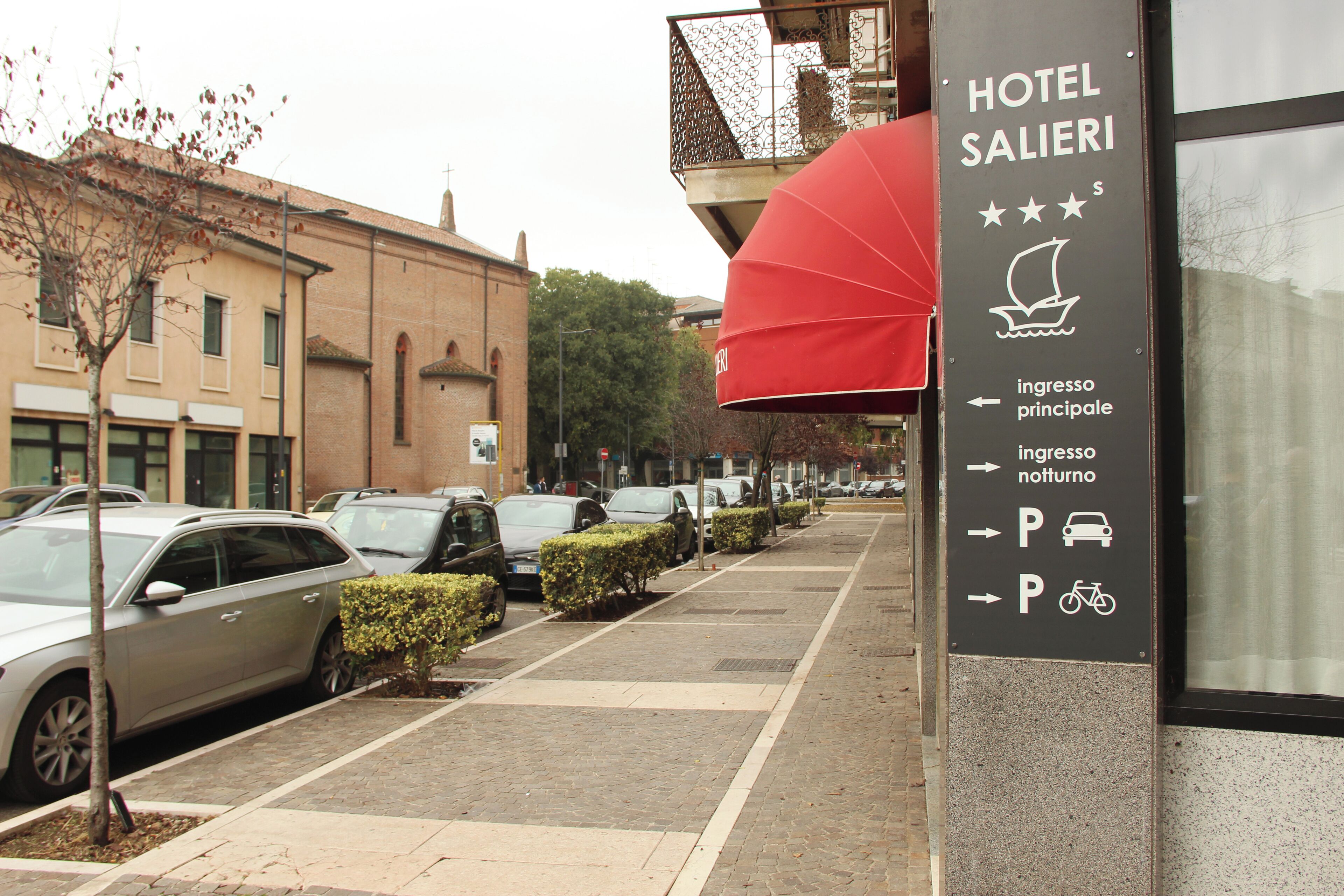 A hotel sign with directions for parking and main entrance.