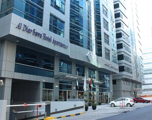 A modern hotel building with the name "Al Dior Sawra Hotel Apartments" prominently displayed.