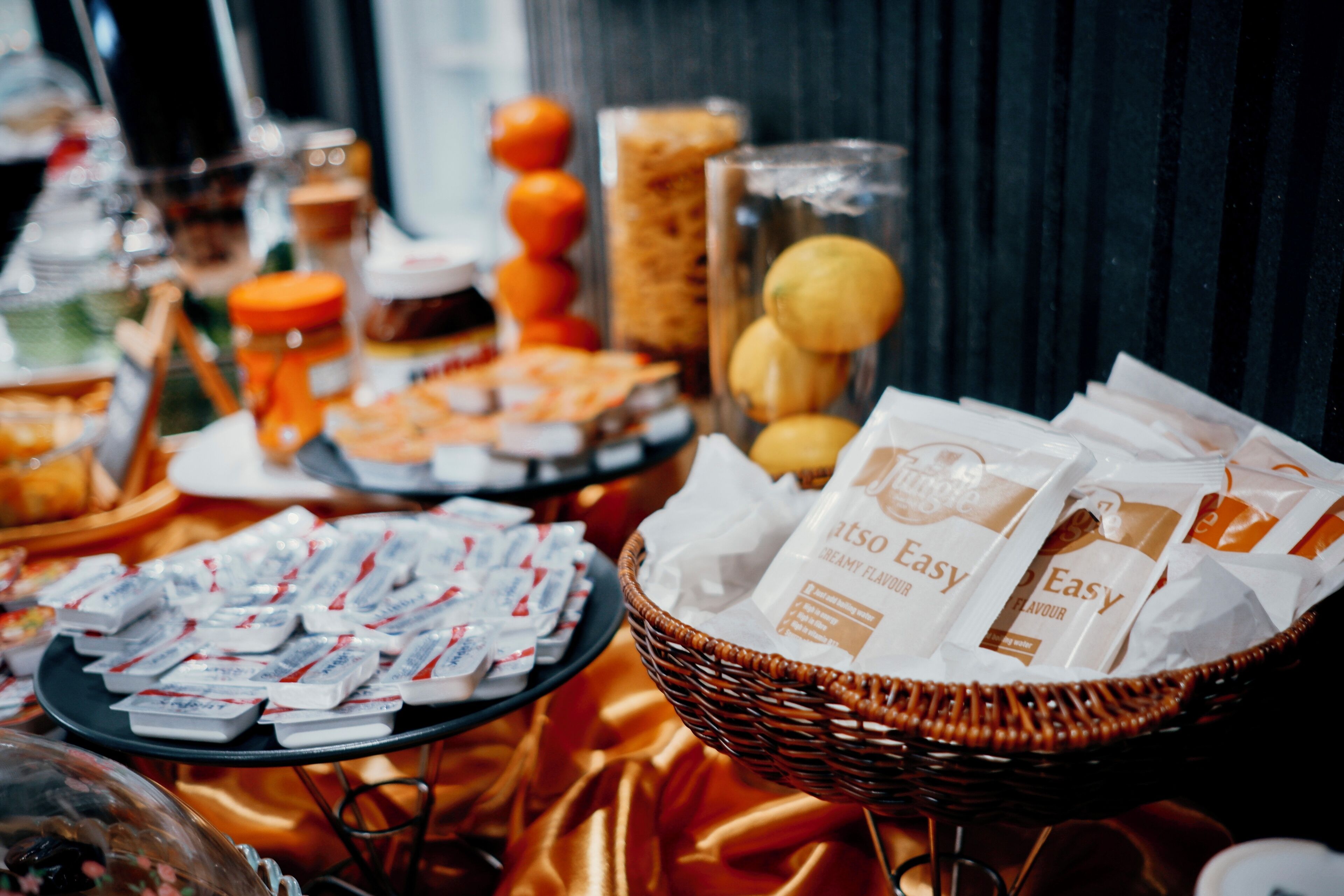A buffet table with various food items and packaged snacks.