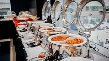 A buffet line with various food stations, including a soup station and a salad station.