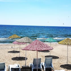 Praia particular, espreguiçadeiras, guarda-sóis