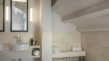 A modern bathroom with a large sink, a bathtub, and a mirror.