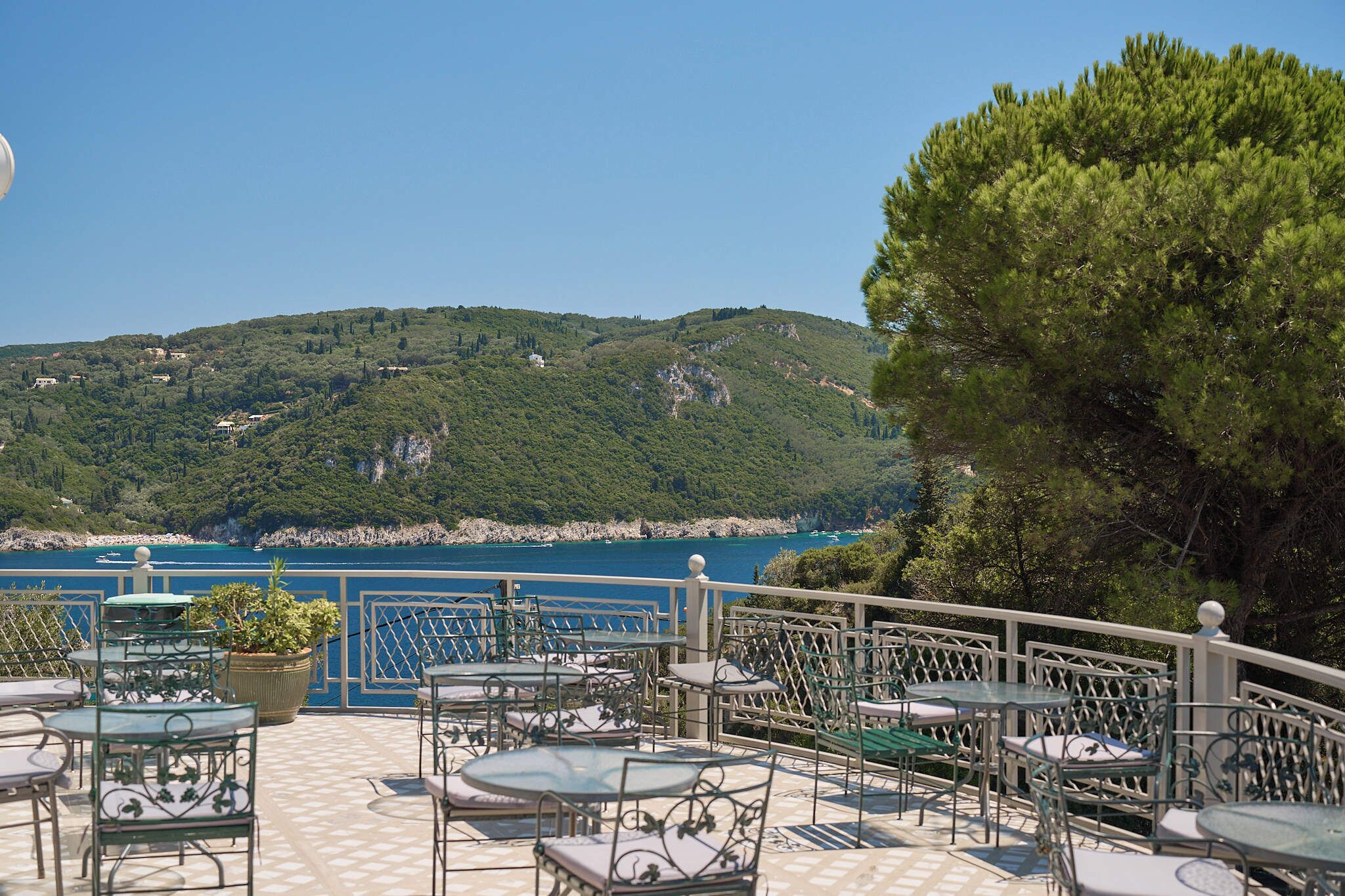 Una terraza con asientos al aire libre con vistas a un paisaje costero.