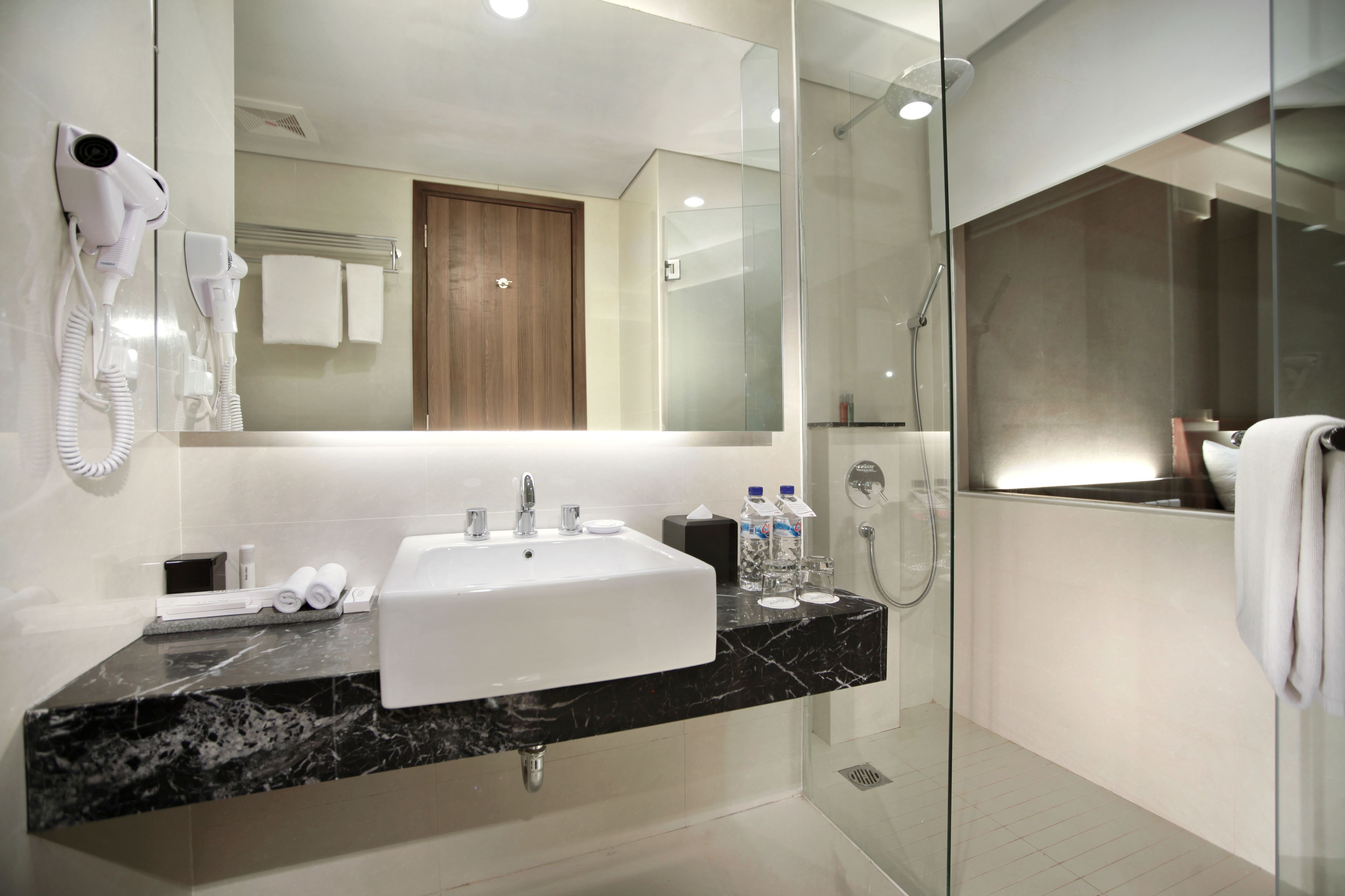 deluxe room | bathroom | shower, rainfall showerhead, free toiletries, slippers