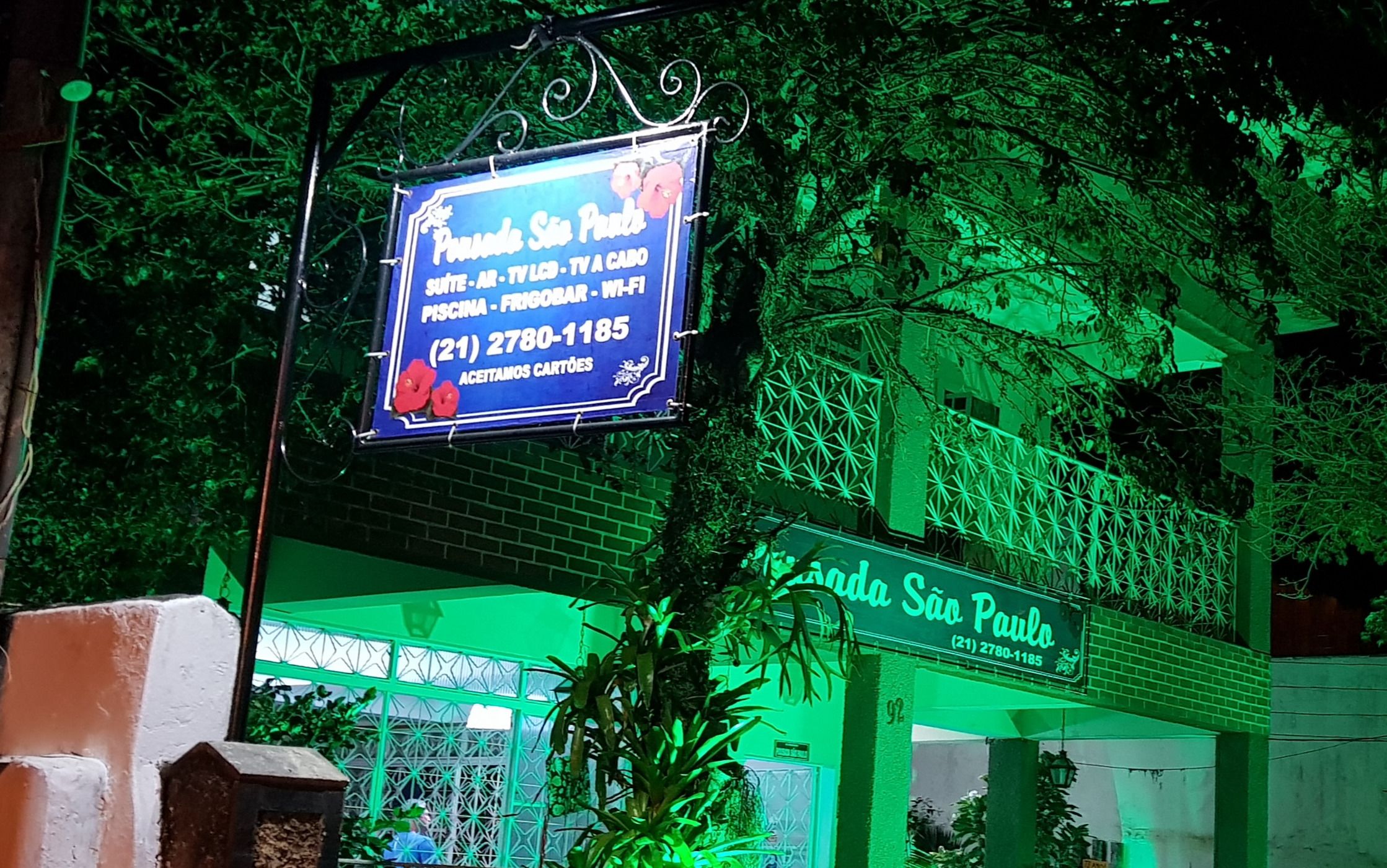 A signboard for 'Panda Sao Paulo' with contact information and amenities listed.