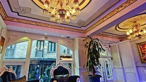 A luxurious hotel lobby with ornate chandeliers, plush seating, and large windows offering views of the street. - Leyenda Hotel (Istanbul)