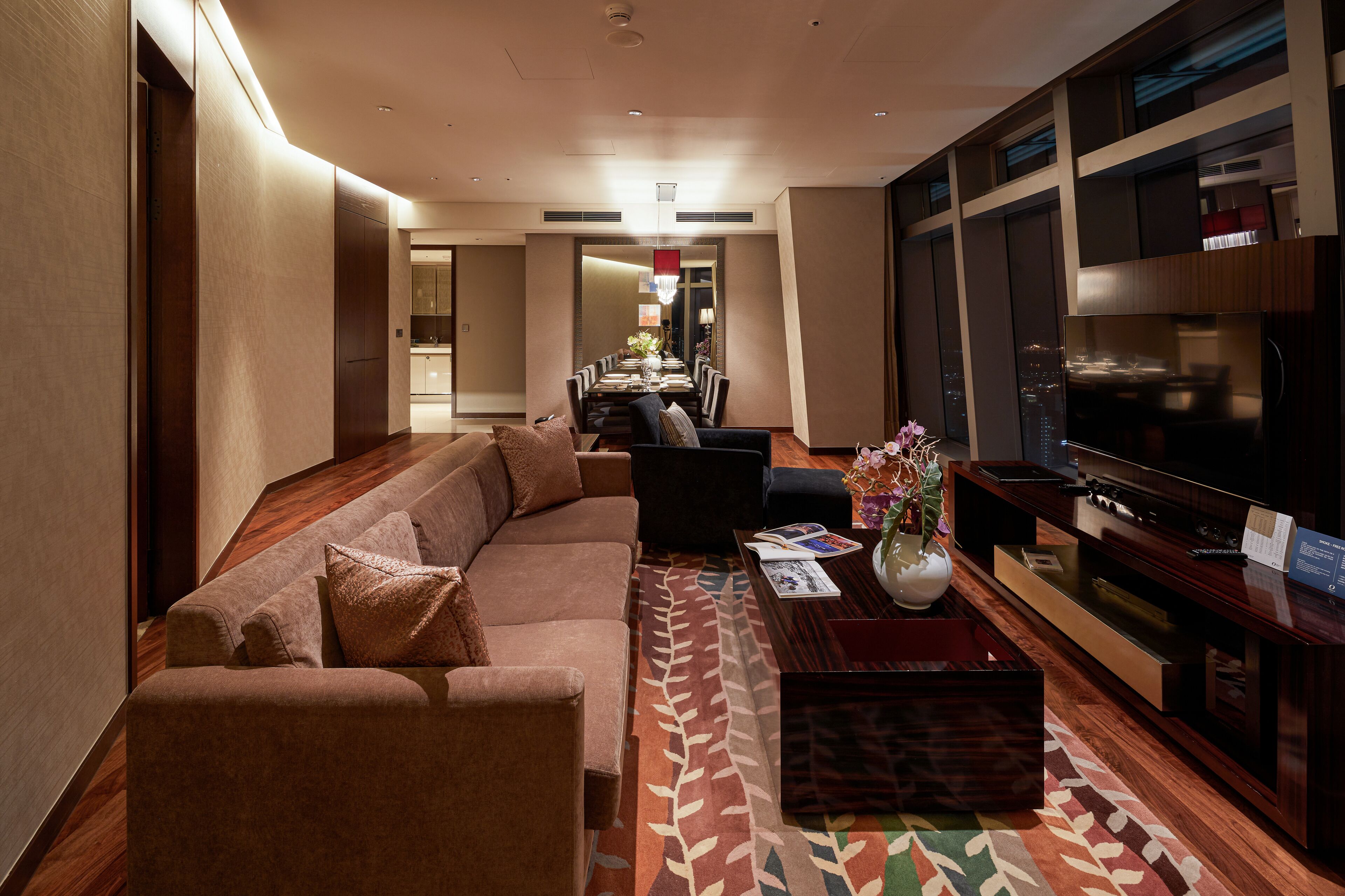 A modern living room with a sofa, coffee table, and TV.