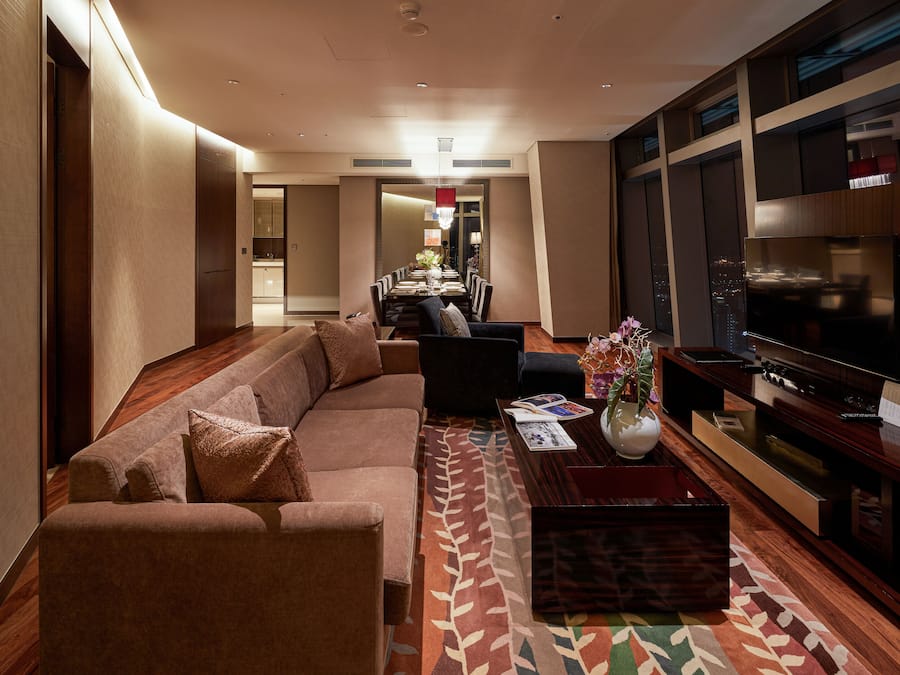 A modern living room with a sofa, coffee table, and TV.