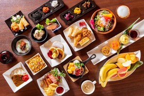 A variety of dishes including pancakes, croissants, and fruit arranged on a wooden table. - KOKO HOTEL Shinjuku Yotsuya (Tokyo)