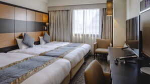 A hotel room with two beds, a desk with a chair, a TV, and a large window with curtains. - KOKO HOTEL Shinjuku Yotsuya (Tokyo)