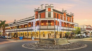 A historic building with a balcony and multiple stories, featuring a prominent 'Rose' sign. - Rose Hotel & Motel (Bunbury)