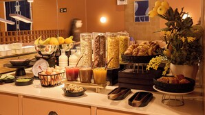 A buffet with various food items and beverages.