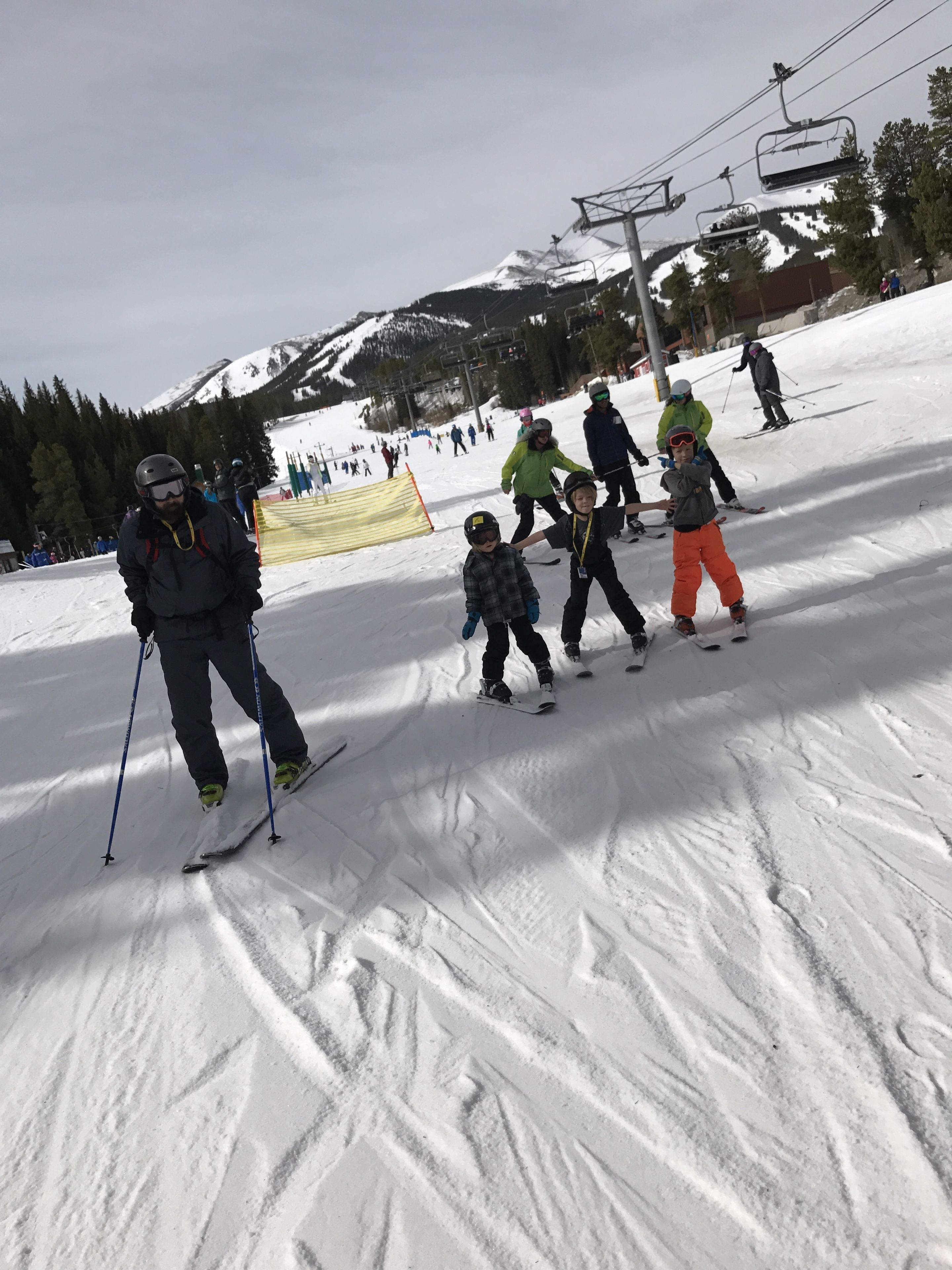 A ski slope with skiers and snowboarders.