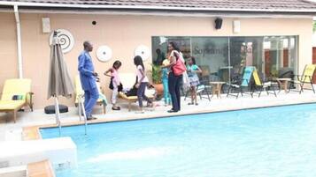 Relax by the pool with lounge chairs and umbrellas, and enjoy easy access via the pool ladder.