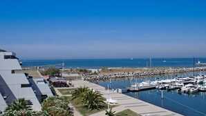 A marina with boats, a lighthouse, and a rocky breakwater. - Les Rivages d'Ulysse (Le Grau-Du-Roi)