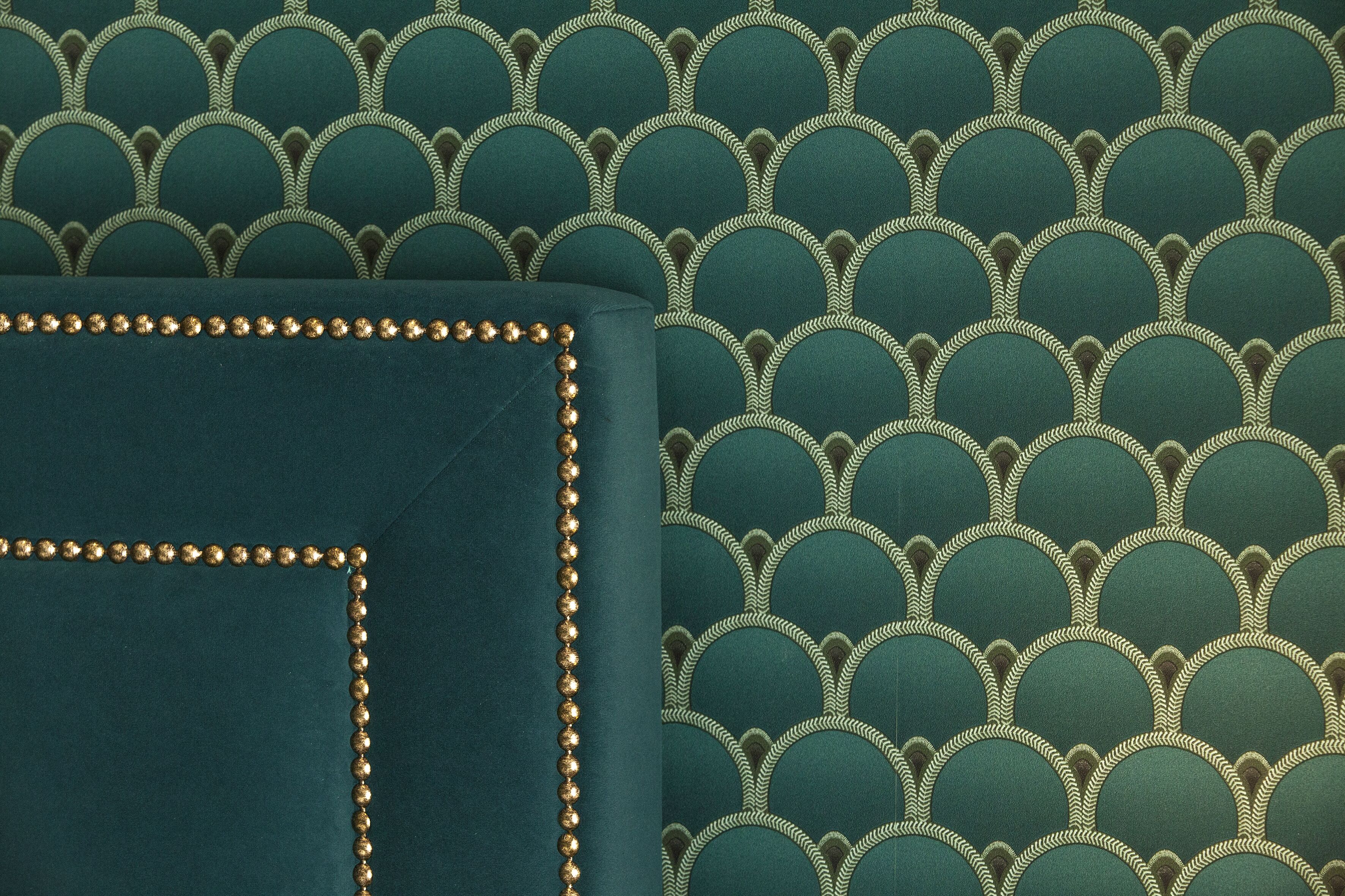 A close-up of a textured fabric with a scalloped pattern and a decorative border.