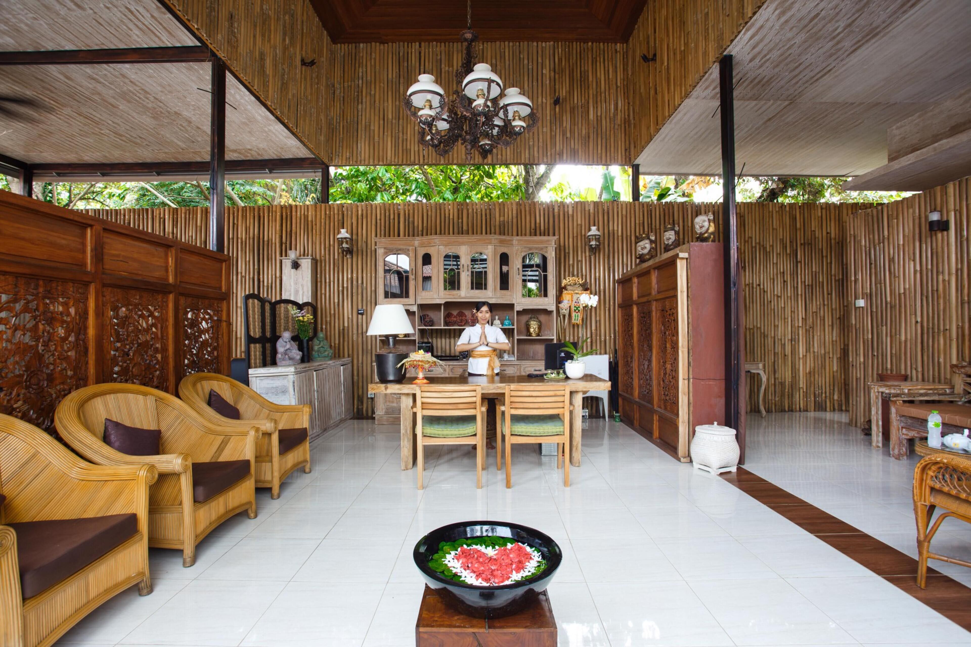 A spacious room with a wooden ceiling, a central dining area with a table and chairs, and a large decorative bowl in the foreground.