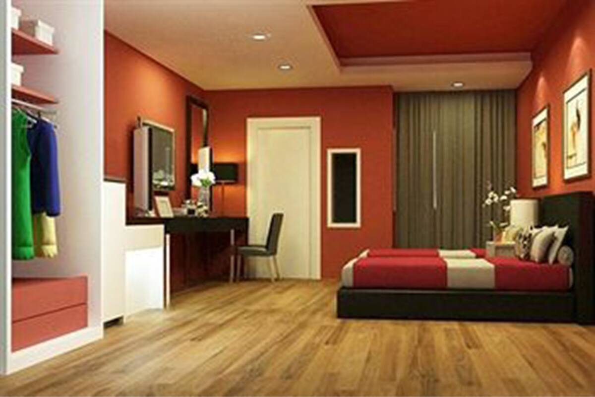 A bedroom with a bed, a desk, a chair, a wardrobe, and a mirror.